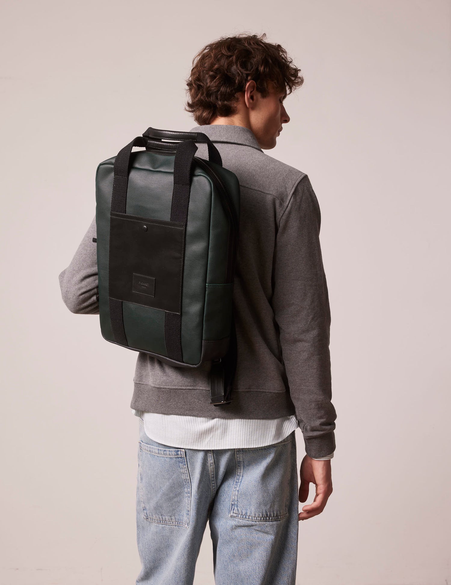 Coated canvas and green leather backpack