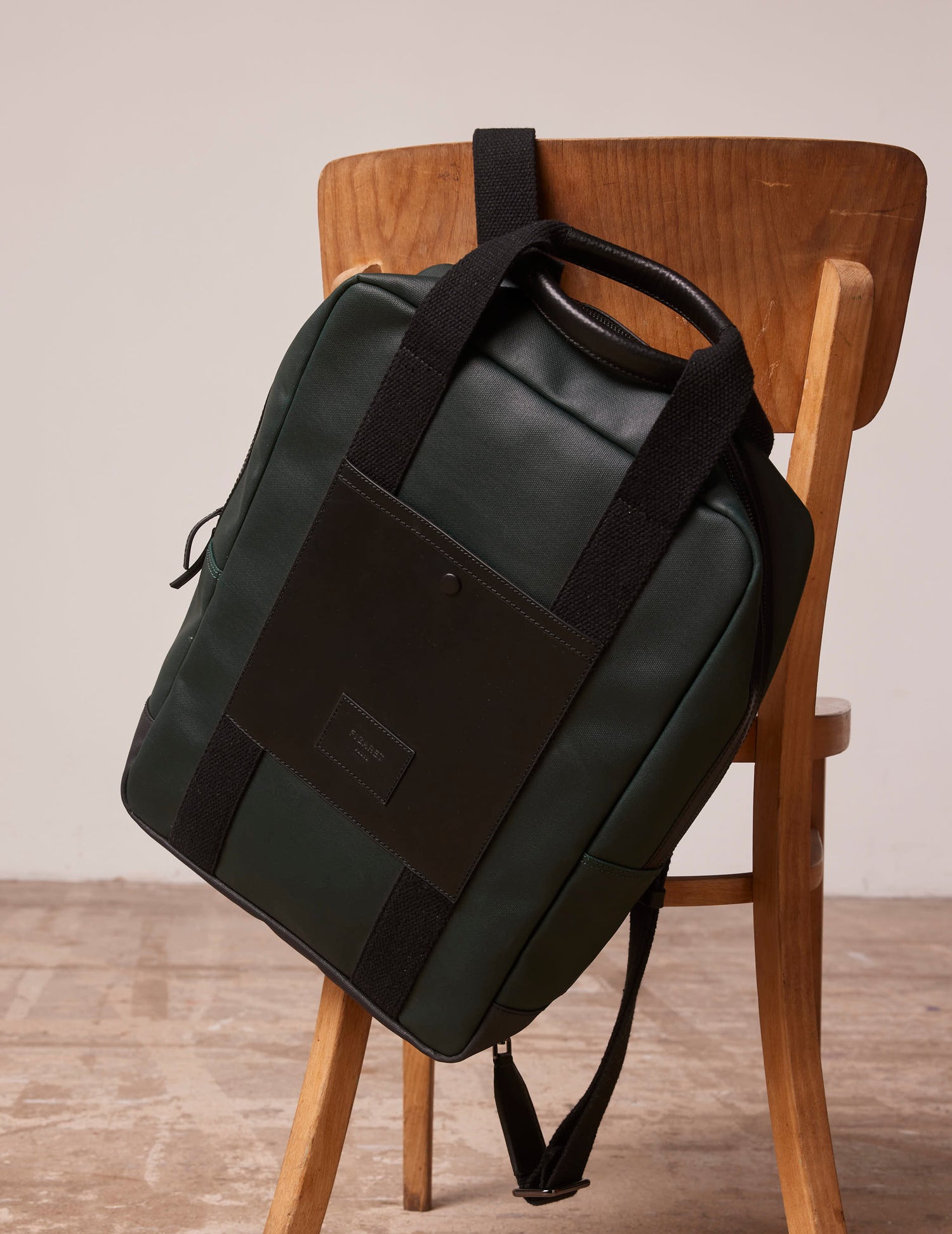 Coated canvas and green leather backpack