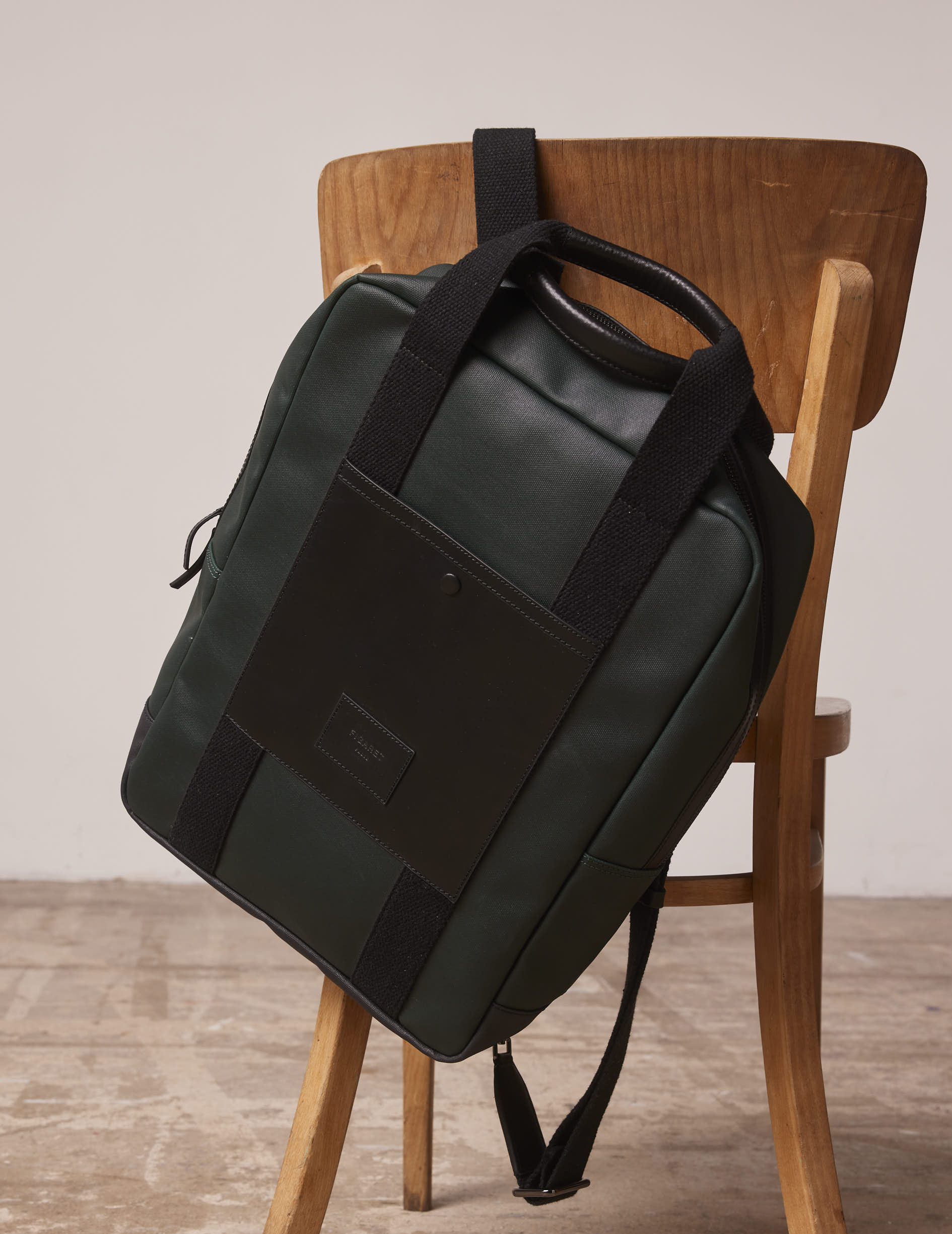 Coated canvas and green leather backpack