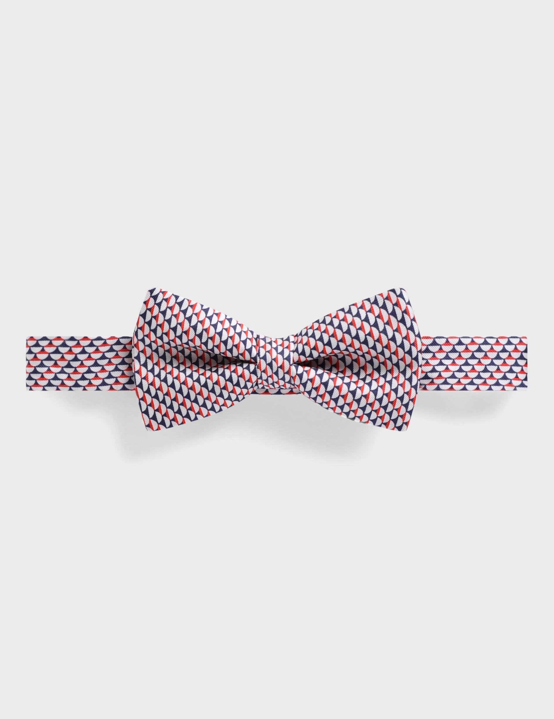 Bow tie with red and navy geometric patterns