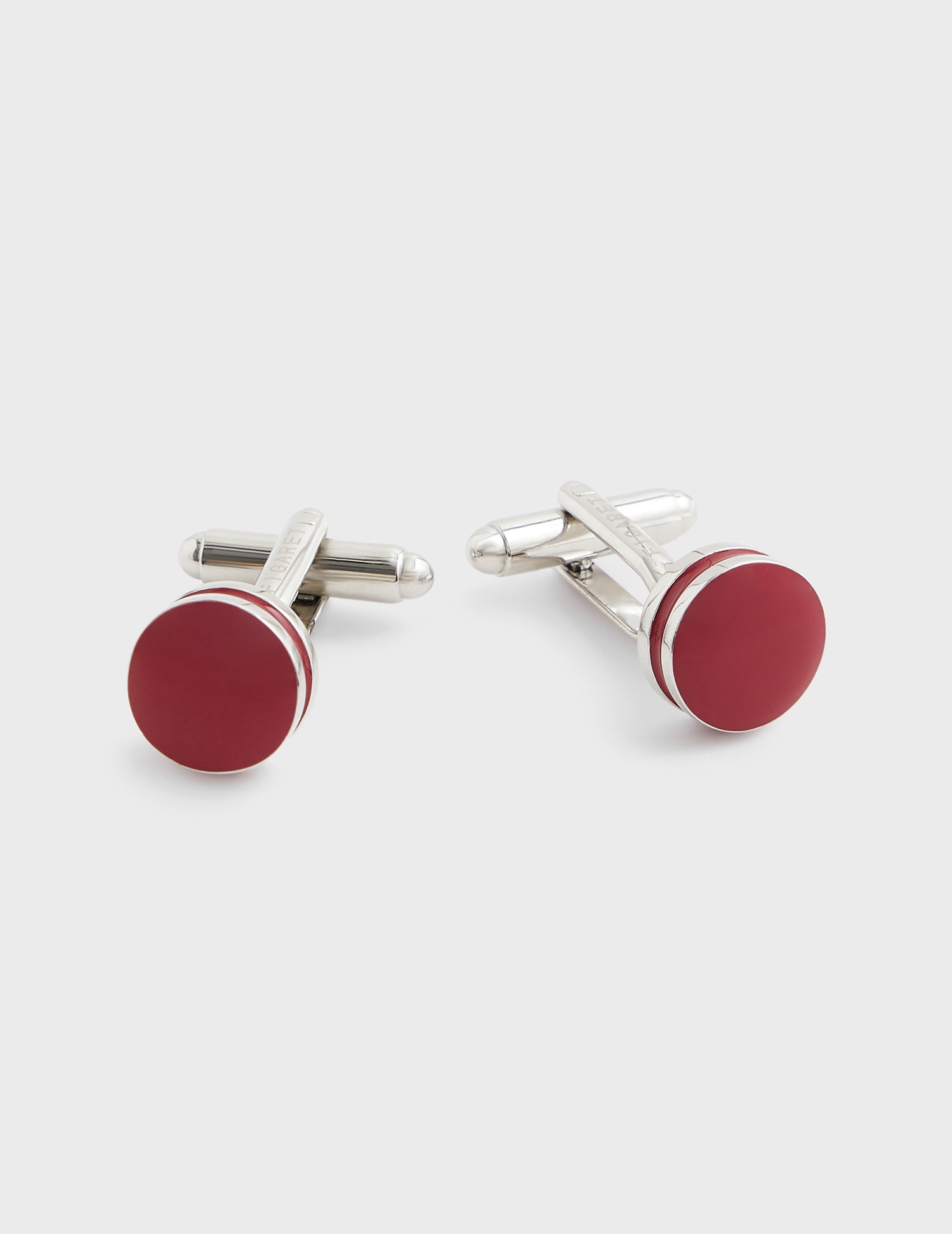 Cufflink with silver hooping and red resin