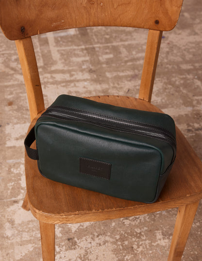 Toiletry bag in coated cotton canvas and green leather